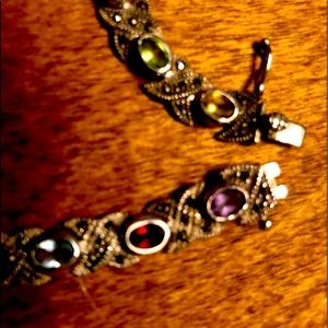 Multi color stones on sterling silver bracelet.